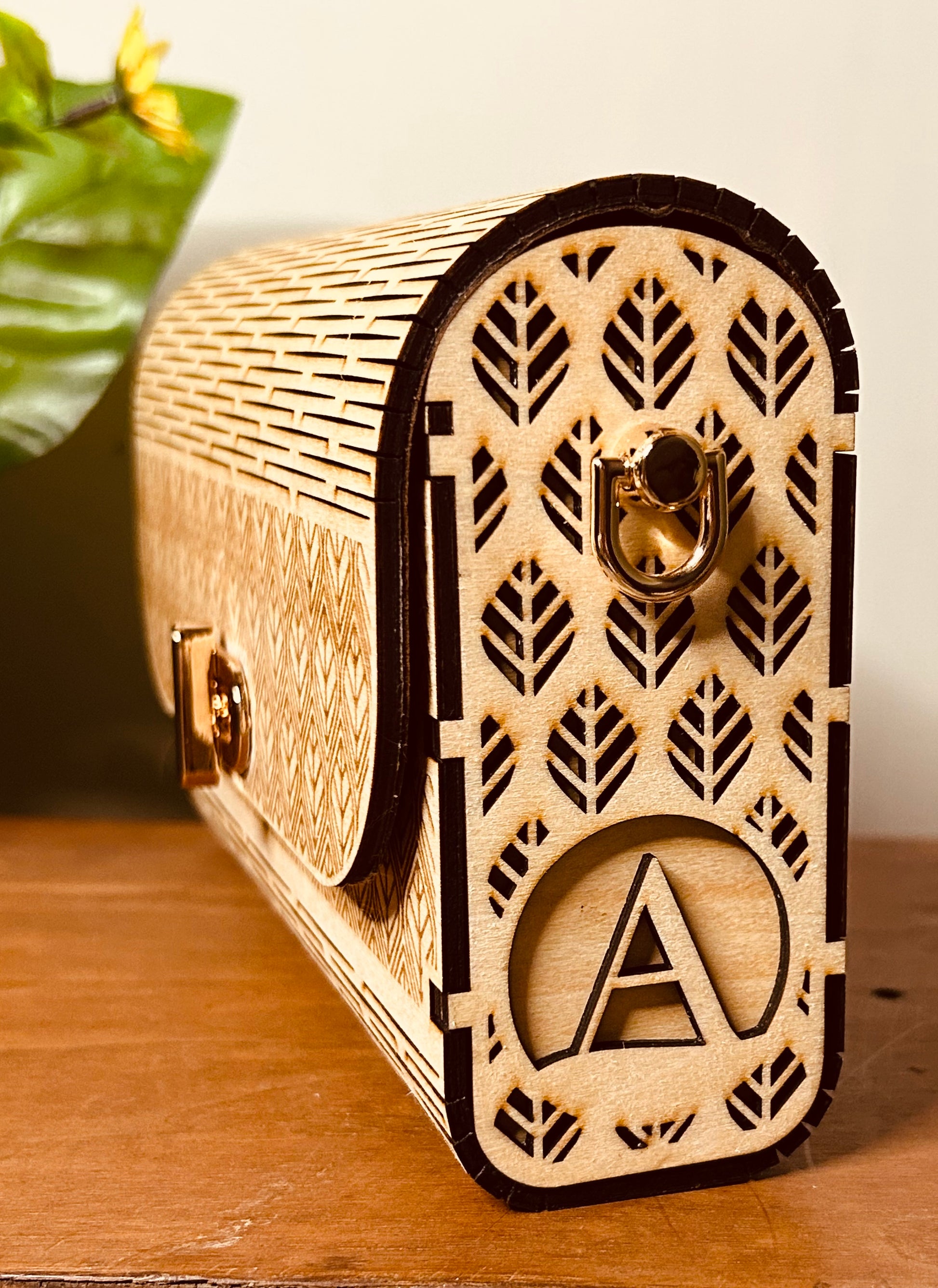 Vue avant du sac en bois personnalisé Mimi de Le Bois Elégant, sur une table en bois, avec des fleurs en arrière-plan.