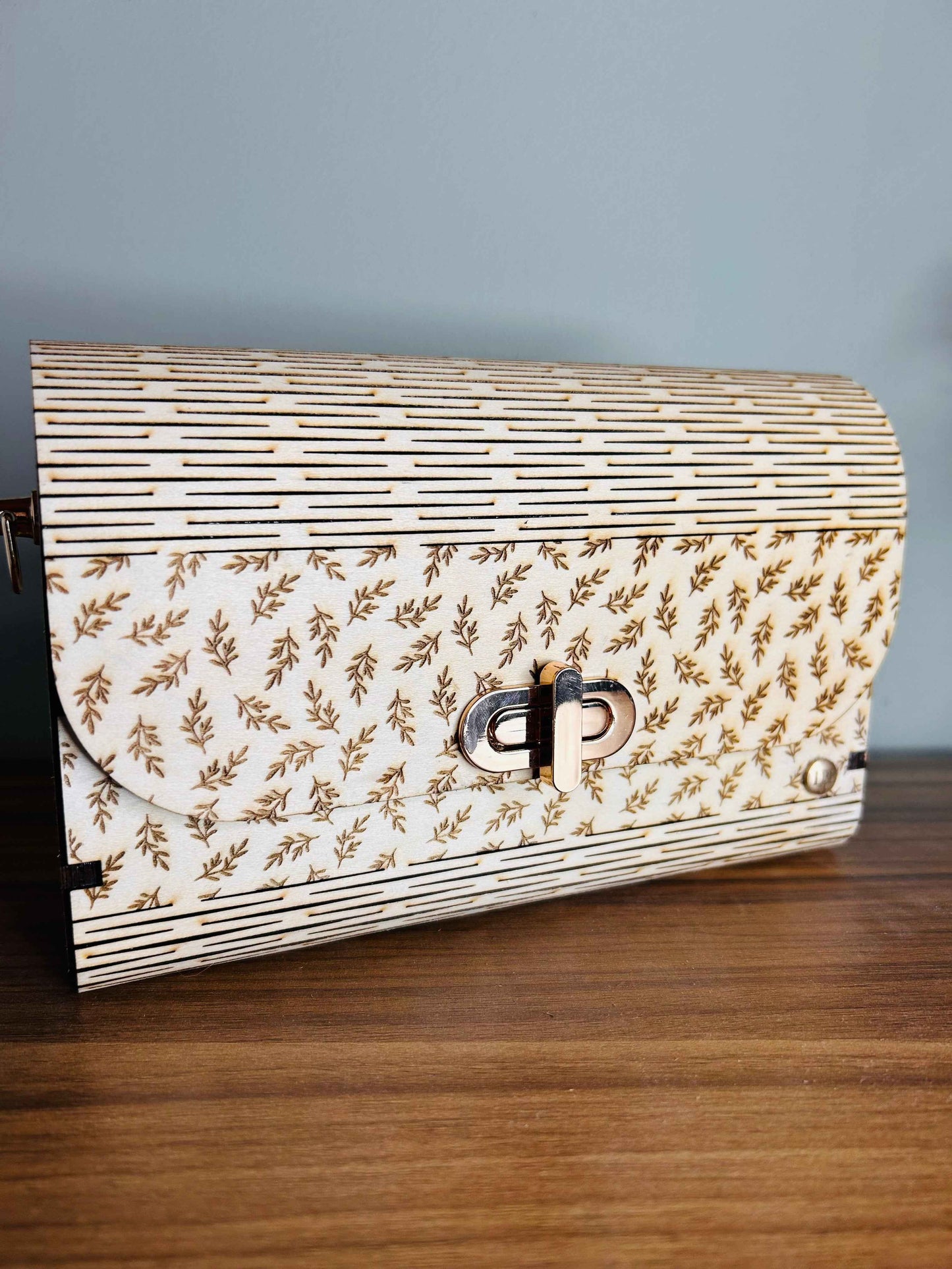Sac romantique Le Bois Elégant en cuir avec détails élégants, visible avec une poignée et fermeture métallique.
